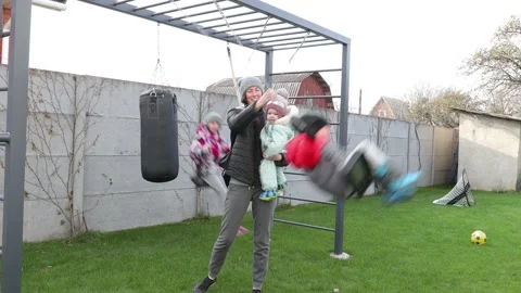 Children playing in the backyard with mother Stock Footage 143712581