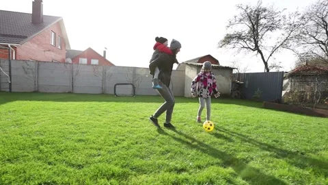 Children playing in the backyard with mother Stock Footage 143712754