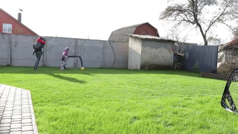 Children playing in the backyard with mother Stock Footage 143712757