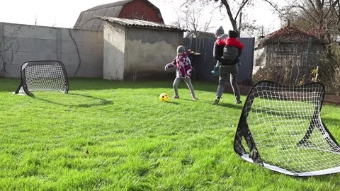 Children playing in the backyard with mother Stock Footage 143712809