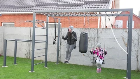 Children playing in the backyard with mother Stock Footage 143712811