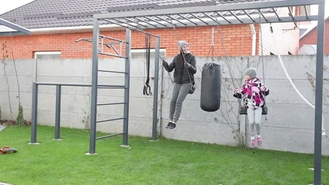 Children playing in the backyard with mother Stock Footage 143712964