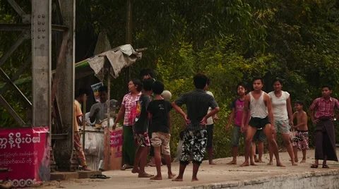 Children playing a ball game at train station slow motion - Myanmar Stock Footage 61449639
