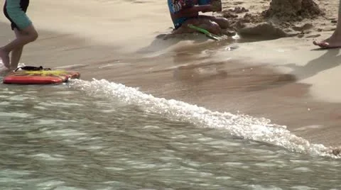 Children playing on the beach Stock Footage 19117359