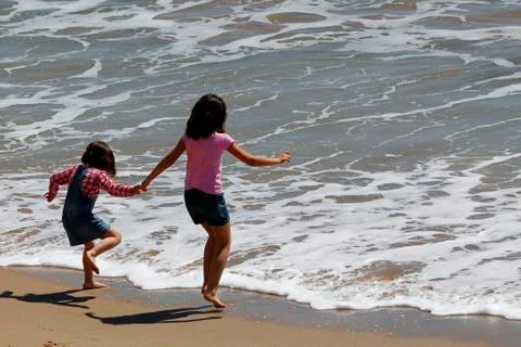 Children playing at the beach Stock Photos