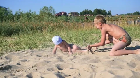 Children playing on the beach with sand Видео 66481777