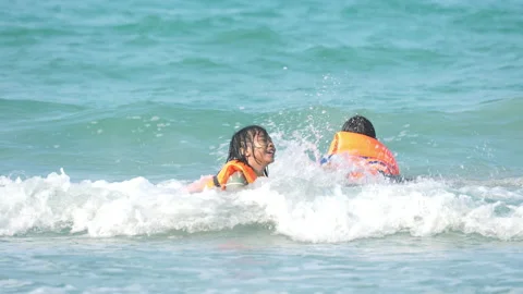 Children playing on beach of sea in summer holiday of vacation time Stockbeeldmateriaal 237699688
