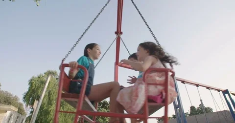 Children playing on a big red swing together Stock-Footage 77963830