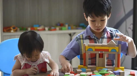 Children playing with blocks on table Stock Footage 52907676
