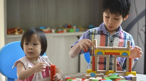 Children playing with blocks on table Stock Footage 52914813