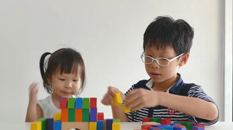 Children playing blocks together Stock Footage 56876106