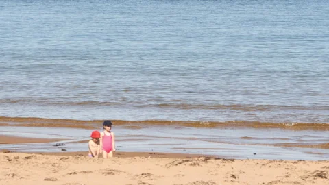 Children playing at Chimney Corner Beach, Cape Breton, Nova Scotia, Canada Stock Footage 231239647