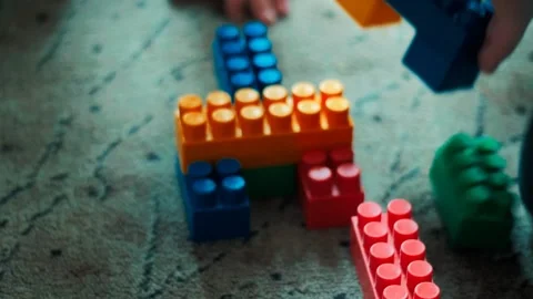 Children playing colorful construction educational toy blocks on the floor build Stock Footage 309090218