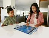 Children Playing On Computer In Table Stock Photos