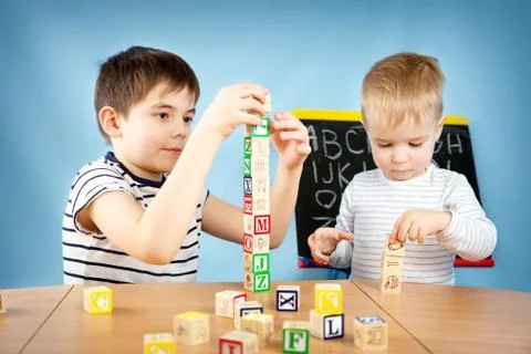 Children playing with cubes on the table Stock Photos