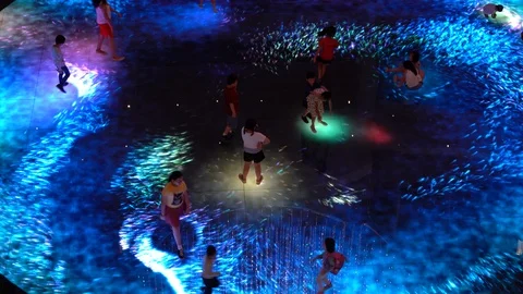 Children playing on Digital Light Canvas at Marina Bay Sands mall in Singapore Stock Footage 112005814