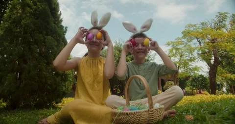 Children playing with Easter eggs. Children playing in the park. Children Stock Footage 305317192