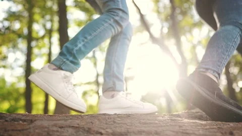 Children playing in the forest park. close-up child feet walking on a fallen Stock Footage 221831745