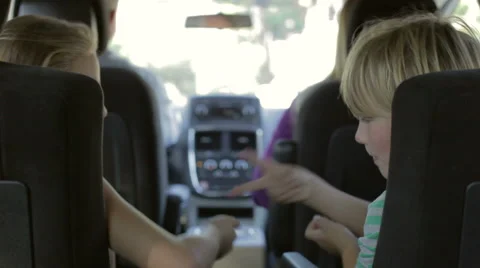 Children Playing Game In Back Seat Of Car On Journey Stock Footage