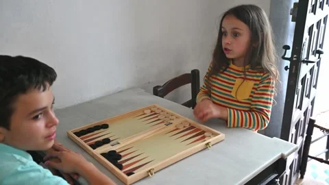 Children playing a game of backgammon at home indoor setting Stock Footage 290050795