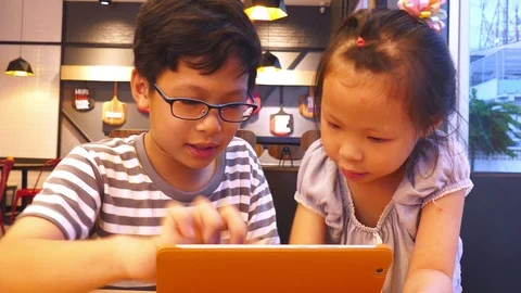 Children playing games on tablet computer together Stock Footage 95505734