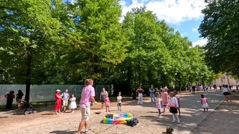 Children Playing with Giant Soap Bubbles in Berlin Park Stock Footage 314813106