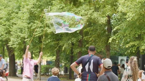Children Playing with Giant Soap Bubbles in Berlin Park Stock Footage 315543075