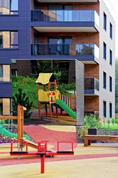 Children playing ground at architectural complex of apartment buildings Stock Photos
