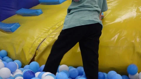 Children playing happily in a ball pit Stock-Footage 297732238