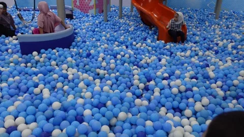 Children playing happily in a pool filled with balls, ball pool Stock Footage 314269715