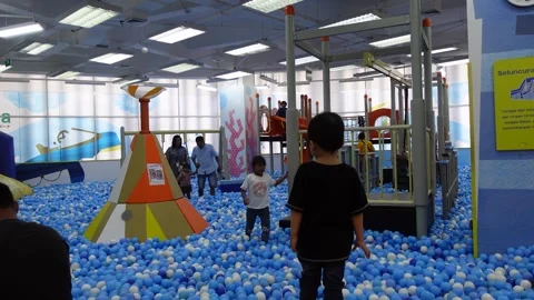 Children playing happily in a pool filled with balls, ball pool Stock Footage 314269716