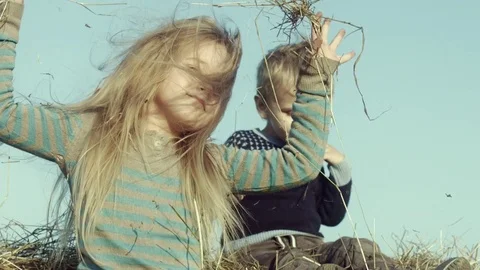 Children playing with hay on the field. Stock Footage 84186087