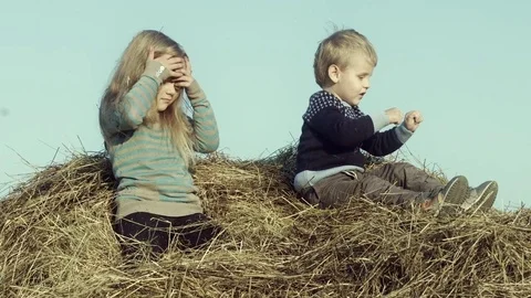 Children playing with hay on the field. Stock Footage 84186147