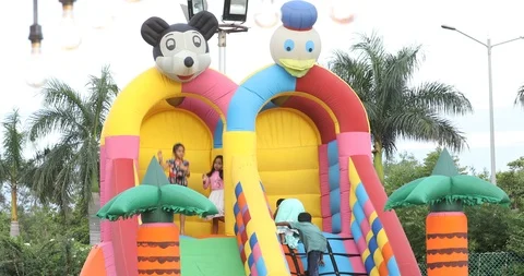 Children Playing On Inflatable Slide Stock Footage 112935061