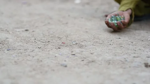 Children playing marbles on the floor Stock Footage 165856098