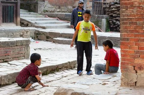 Children Playing Marbles Stock Photos