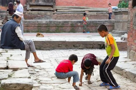 Children Playing Marbles Stock Photos