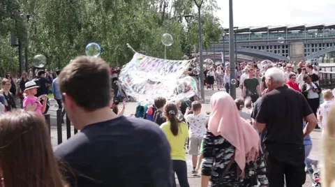 Children Playing With Massive Bubbles, South Bank Of River Thames, London, UK Stock Footage 66373934