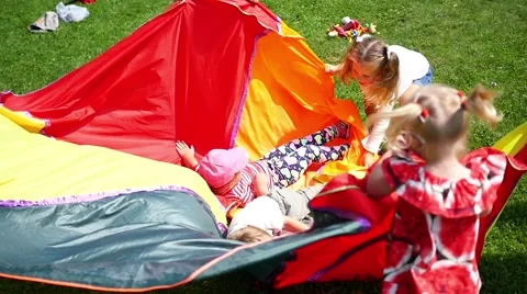 Children playing in a meadow in the Park Stock Footage 65366409