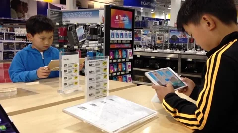 Children playing new app game inside store Stock Footage 54975383