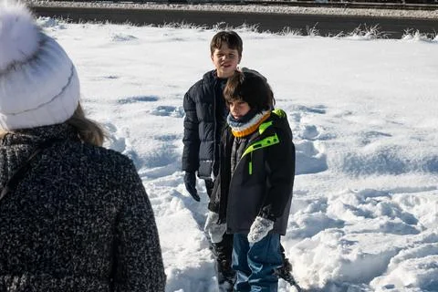 Children playing outdoors in fresh snow during winter Stock Photos