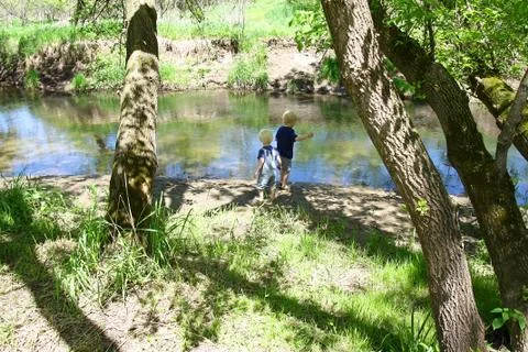 Children playing outside at the river Stock Photos