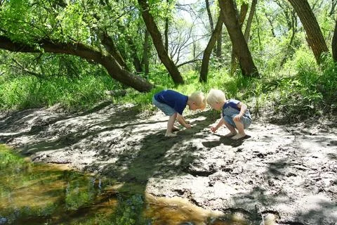 Children playing outside at the river Stock Photos