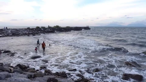 Children playing with parents at the beach during sunset. Stock Footage 296796045