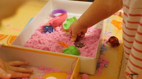 Children playing with pink play sand/magic sand Stock Footage 86290331