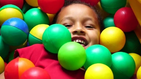 Children playing in plastic pool full colourful balls Stock Footage 81494692