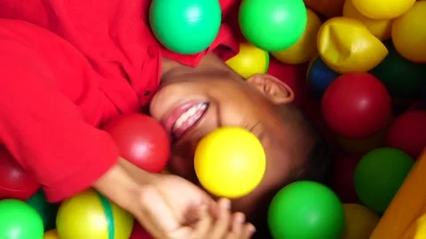 Children playing in plastic pool full colourful balls Stock Footage 81494732