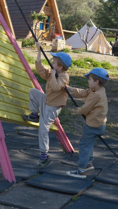 Children playing on playground equipment, representing active lifestyle and Stock Footage 332901153