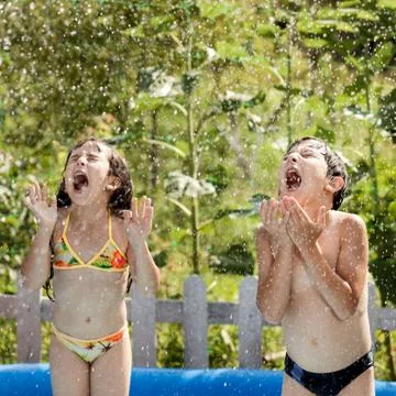 Children playing in the rain Stock Photos