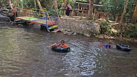 Children playing in the river Stock Footage 252412487